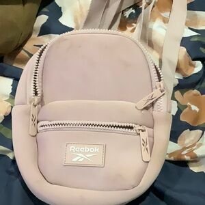 It a pink Reebok mini backpack